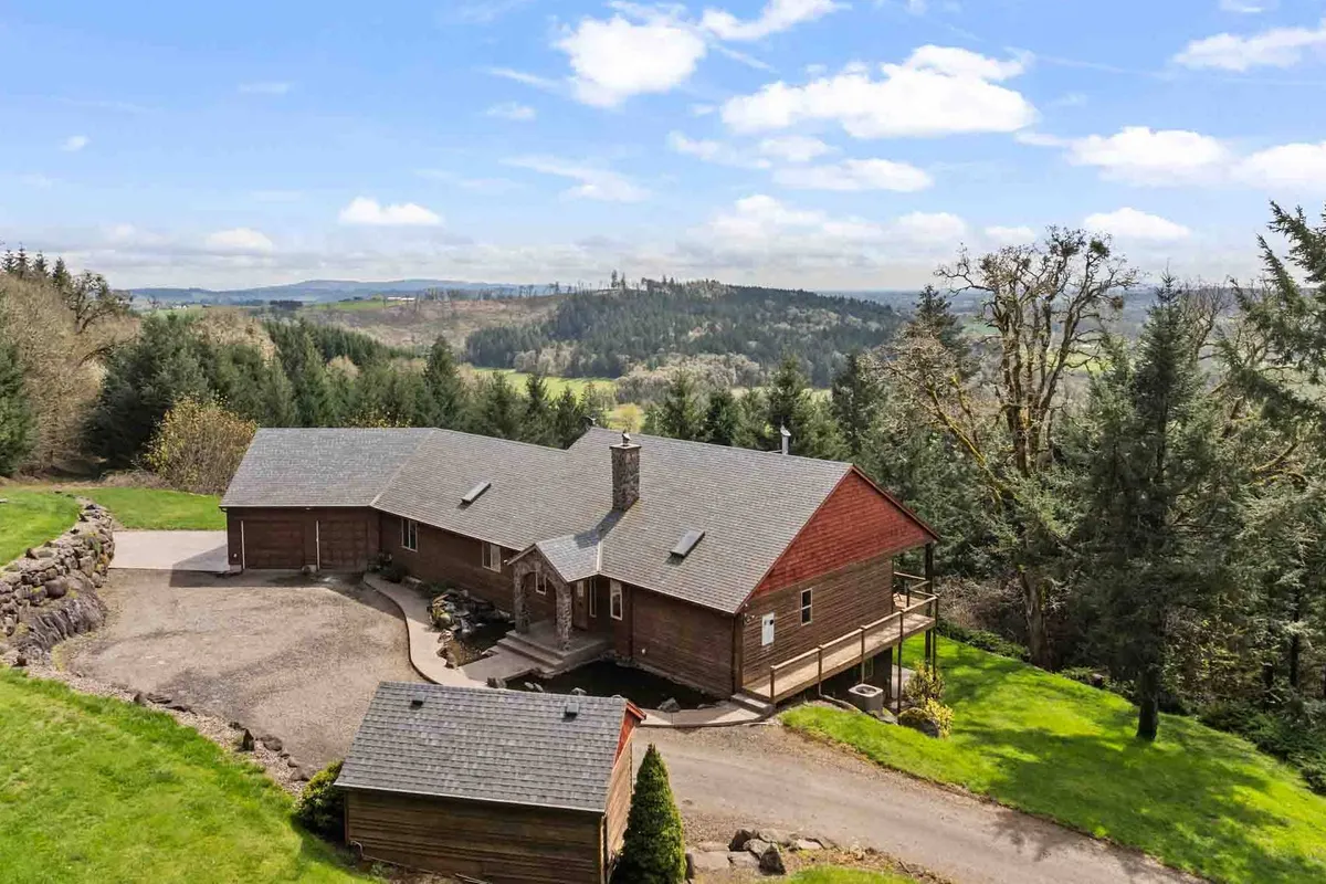 This image features Mt. Richmond Manor nestled amid lush greenery with an expansive mountain view in the background. The house sits peacefully within its natural surroundings, evoking a sense of tranquility and connection to nature.
